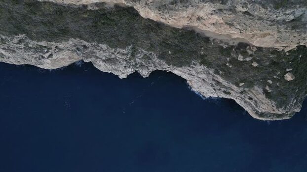 Aerial view of rugged cliffs meeting the Mediterranean Sea Spain.