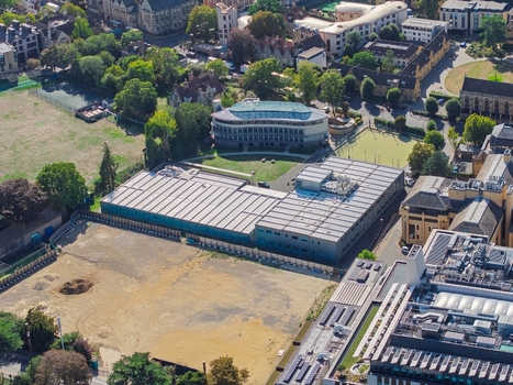 Aerial view of the Data Center at Oxford University featuring an industrial building with a flat roof surrounded by green spaces and historic architecture in Oxford England United Kingdom. Aerial view of the Data Center at Oxford University featuring an industrial building with a flat roof surrounded by green spaces and historic architecture in Oxford England United Kingdom.