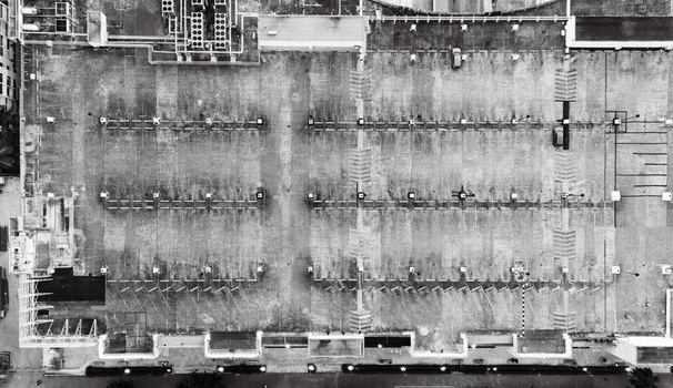 Aerial view of a large parking lot with marked spaces ventilation units and a few parked cars in Santo Domingo Dominican Republic. Aerial view of a large parking lot with marked spaces ventilation units and a few parked cars in Santo Domingo Dominican Republic.