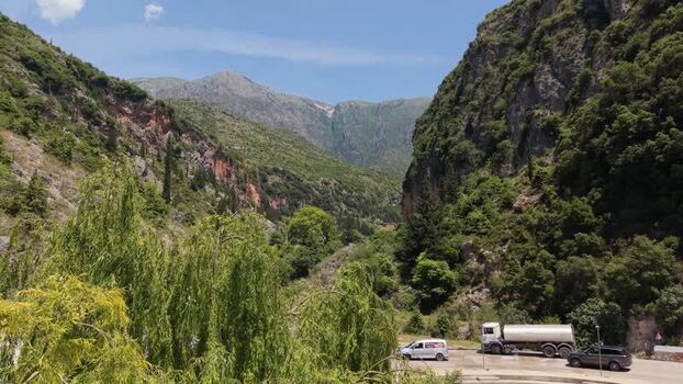 Aerial view of mountain road with vehicles in Himare Albania.