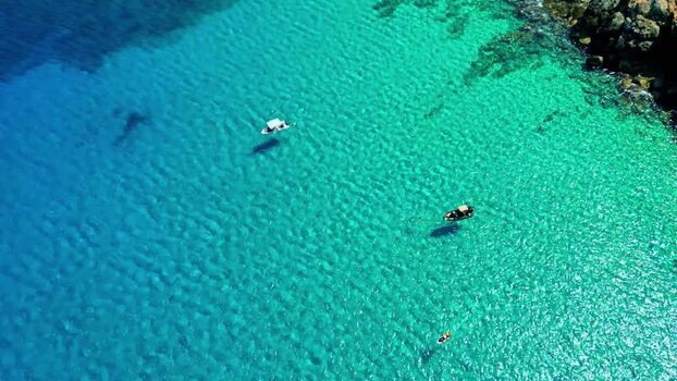 Aerial view of boats in the turquoise waters of Crete Greece.