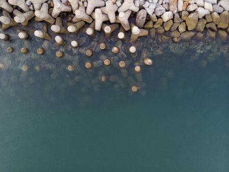 Aerial view of concrete tetrapods forming a breakwater along the coastline in the clear turquoise waters of La Cruz de Huanacaxtle Nayarit Mexico. Aerial view of concrete tetrapods forming a breakwater along the coastline in the clear turquoise waters of La Cruz de Huanacaxtle Nayarit Mexico.