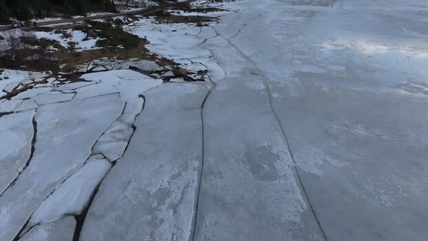 Aerial view of cracked ice on a frozen lake in Lofoten Norway.