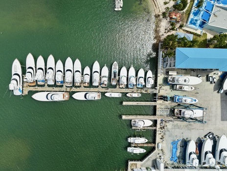 Aerial view of Peanut Island with luxury white yachts docked at a marina pier along turquoise waters in Palm Beach County Florida United States.