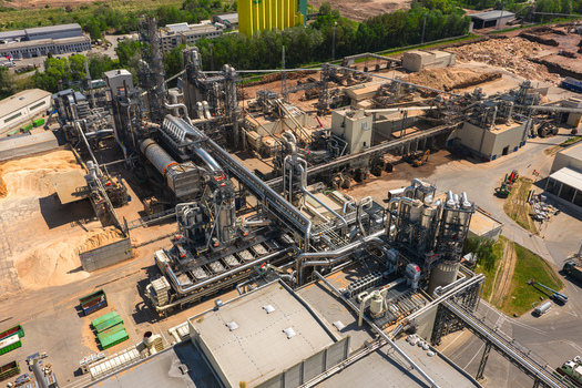 Aerial view of a large industrial wood processing plant with complex machinery conveyor belts and piles of timber Jihlava Vysocina Region Czechia.
