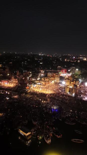 Aerial view of Dashashwamedh Ghat with crowds and boats at night India. Aerial view of Dashashwamedh Ghat with crowds and boats at night India.