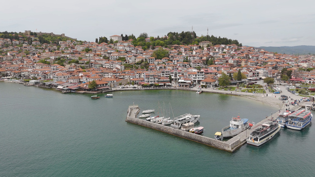 Aerial view of the historic town of Ohrid with its traditional red tiled rooftops stone buildings and the harbor on Lake Ohrid in Ohrid Municipality of Ohrid North Macedonia. Aerial view of the historic town of Ohrid with its traditional red tiled rooftops stone buildings and the harbor on Lake Ohrid in Ohrid Municipality of Ohrid North Macedonia.