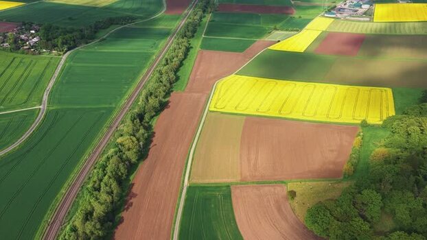 Aerial view of colorful agricultural fields and railway Germany.