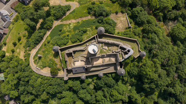 Aerial view of Nurburg Castle with its historic stone walls towers and surrounding lush forest in Nurburg Rhineland Palatinate Germany. Aerial view of Nurburg Castle with its historic stone walls towers and surrounding lush forest in Nurburg Rhineland Palatinate Germany.