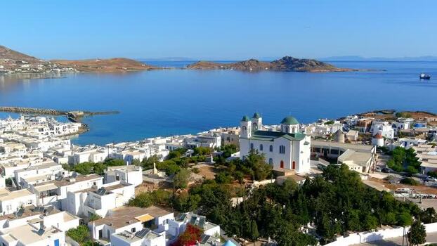 Aerial view of a coastal town with a church in Greece. Aerial view of a coastal town with a church in Greece.