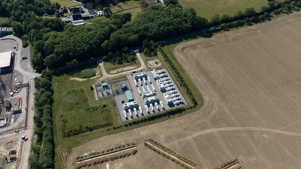 Aerial view of the Pelham Storage Limited battery energy storage facility with rows of white containers and electrical infrastructure in rural Bishop s Stortford England United Kingdom. Aerial view of the Pelham Storage Limited battery energy storage facility with rows of white containers and electrical infrastructure in rural Bishop s Stortford England United Kingdom.