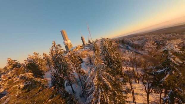 FPV aerial view of Grosser Feldberg transmitter towers Germany.