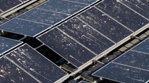 Aerial view of floating solar panels covered in bird droppings and dirt on a sunny day in Zwolle Overijssel Netherlands. Aerial view of floating solar panels covered in bird droppings and dirt on a sunny day in Zwolle Overijssel Netherlands.
