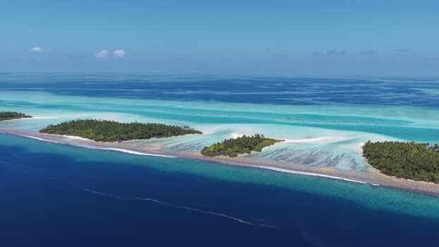 Aerial view of tropical islands and turquoise lagoons Maldives.