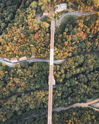 Aerial view of the historic Fades viaduct surrounded by dense autumn forests and winding roads in Les Ancizes Comps Auvergne Rhone Alpes France. Aerial view of the historic Fades viaduct surrounded by dense autumn forests and winding roads in Les Ancizes Comps Auvergne Rhone Alpes France.