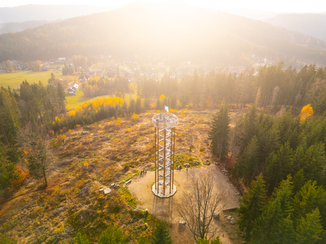 Aerial view of Svetly vrch lookout tower surrounded by autumn forests and hills in Albrechtice v Jizerskych horach Liberecky kraj Czechia. Aerial view of Svetly vrch lookout tower surrounded by autumn forests and hills in Albrechtice v Jizerskych horach Liberecky kraj Czechia.