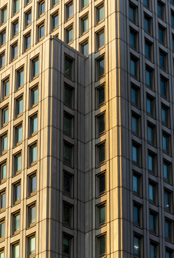 View of modern skyscraper facade with geometric window patterns and golden sunlight Taipei City Taiwan. View of modern skyscraper facade with geometric window patterns and golden sunlight Taipei City Taiwan.