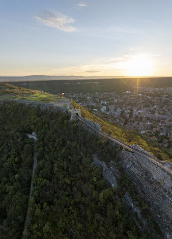 Aerial view of Ovech Fortress perched on a rocky plateau overlooking the town of Provadia at sunset with lush green forests and golden light Provadia Varna Bulgaria. Aerial view of Ovech Fortress perched on a rocky plateau overlooking the town of Provadia at sunset with lush green forests and golden light Provadia Varna Bulgaria.