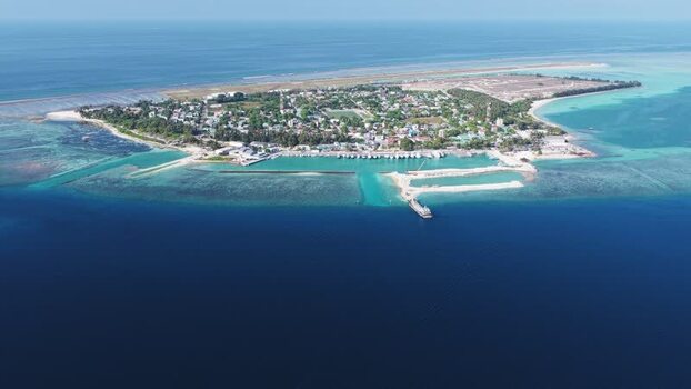 Aerial view of Kudahuvadhoo island and turquoise waters Maldives. Aerial view of Kudahuvadhoo island and turquoise waters Maldives.