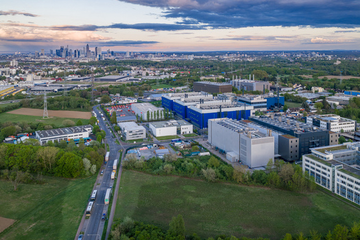 Aerial view of the Digital Realty Frankfurt FRA30 data center complex with the city skyline in the background under a sunset sky in Frankfurt am Main Hessen Germany. Aerial view of the Digital Realty Frankfurt FRA30 data center complex with the city skyline in the background under a sunset sky in Frankfurt am Main Hessen Germany.