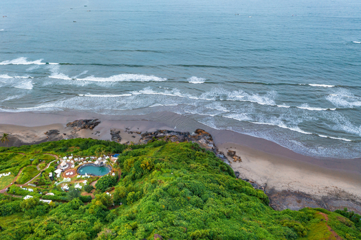 Aerial view of resort with pool on the coast of Goa India.