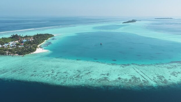 Aerial view of a tropical island and turquoise lagoon Maldives. Aerial view of a tropical island and turquoise lagoon Maldives.