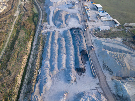 Aerial view of a large industrial quarry site with piles of gravel and sand heavy machinery and trucks operating on dirt roads in Istanbul Istanbul Turkiye.