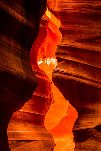 View of Antelope Canyon featuring smooth flowing sandstone walls illuminated by warm natural light in Coconino County Arizona United States. View of Antelope Canyon featuring smooth flowing sandstone walls illuminated by warm natural light in Coconino County Arizona United States.