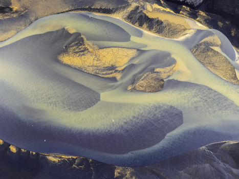 Aerial view of the intricate braided patterns of a glacial river delta with silt deposits and sandbars in Hallgeirseyjarvegur Rangarthing eystra Iceland. Aerial view of the intricate braided patterns of a glacial river delta with silt deposits and sandbars in Hallgeirseyjarvegur Rangarthing eystra Iceland.