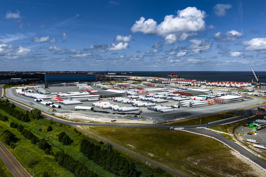 Aerial view of Siemens Gamesa Renewable Energy facility with rows of wind turbine blades stored in an industrial yard near the coast Cuxhaven Niedersachsen Germany.