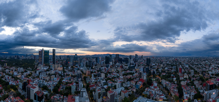 Mexico City Mexico 25 September 2026 Aerial view of the Mexico City skyline at dusk featuring modern skyscrapers dense urban areas and dramatic storm clouds over the horizon. Mexico City Mexico 25 September 2026 Aerial view of the Mexico City skyline at dusk featuring modern skyscrapers dense urban areas and dramatic storm clouds over the horizon.