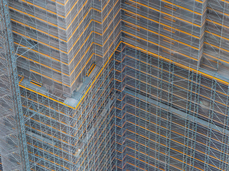 Aerial view of the Steglitzer Kreisel skyscraper facade covered in extensive metal scaffolding during renovation work Berlin Berlin Germany. Aerial view of the Steglitzer Kreisel skyscraper facade covered in extensive metal scaffolding during renovation work Berlin Berlin Germany.
