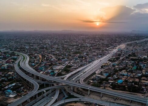 Aerial view of a large highway interchange with multi level roads and ramps winding through an urban landscape in Ghana. Aerial view of a large highway interchange with multi level roads and ramps winding through an urban landscape in Ghana.