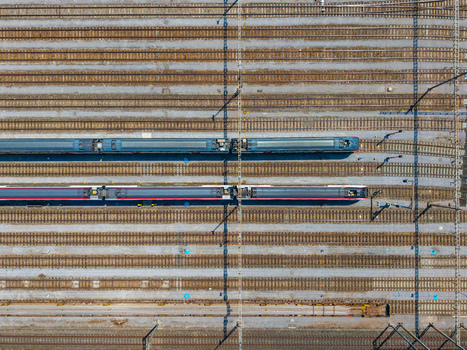 Aerial view of Daniken train station with two passenger trains parked on parallel tracks in Daniken Solothurn Switzerland.