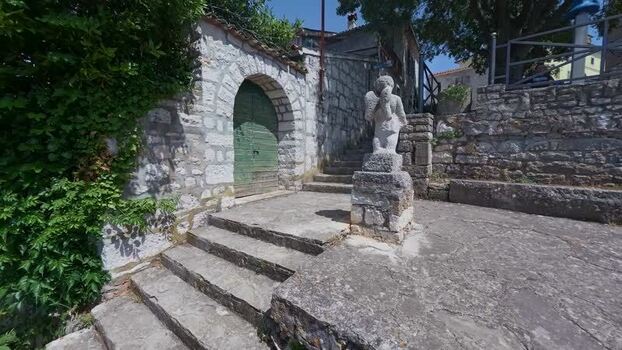 View of stone staircase and statue in Vrsar Croatia.