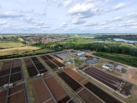 Aerial view of Broadholme water recycling centre with its large treatment tanks and filtration beds surrounded by green fields and nearby lakes in Rushden England United Kingdom. Aerial view of Broadholme water recycling centre with its large treatment tanks and filtration beds surrounded by green fields and nearby lakes in Rushden England United Kingdom.