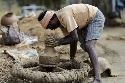 Odisha India 26 March 2026 View of a potter s weathered hands molding clay on a spinning wheel earth tones contrasting with the artisan s vibrant head wrap. Odisha India 26 March 2026 View of a potter s weathered hands molding clay on a spinning wheel earth tones contrasting with the artisan s vibrant head wrap.
