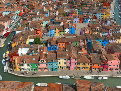 Aerial view of vibrant houses reflecting in the canals creating a stunning mosaic of colors in Burano Venice Veneto Italy. Aerial view of vibrant houses reflecting in the canals creating a stunning mosaic of colors in Burano Venice Veneto Italy.