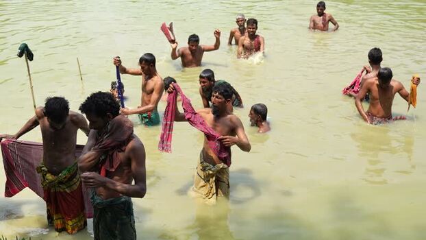 View of men bathing in a river in Natore Bangladesh. View of men bathing in a river in Natore Bangladesh.