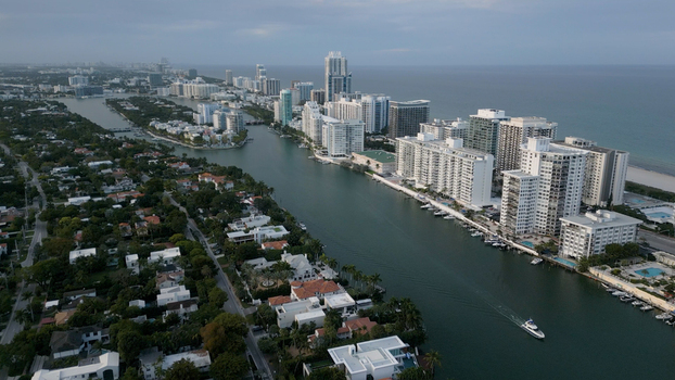 Aerial view of the coastal skyline and residential buildings along the waterway in Miami Beach Florida United States. Aerial view of the coastal skyline and residential buildings along the waterway in Miami Beach Florida United States.