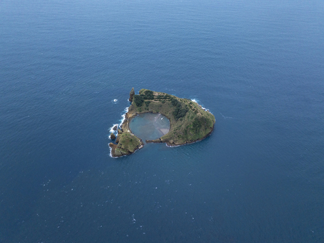 Aerial view of Ilheu de Vila Franca do Campo a volcanic islet with a natural circular lagoon surrounded by deep blue Atlantic ocean waters in Sao Pedro Acores Portugal. Aerial view of Ilheu de Vila Franca do Campo a volcanic islet with a natural circular lagoon surrounded by deep blue Atlantic ocean waters in Sao Pedro Acores Portugal.