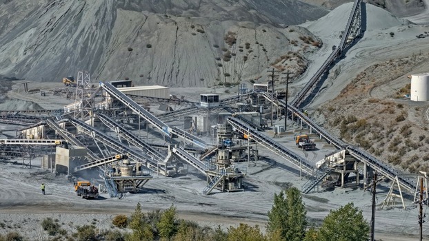 Aerial view of an industrial quarry site with conveyor belts crushers and piles of gravel in Golden Colorado United States.