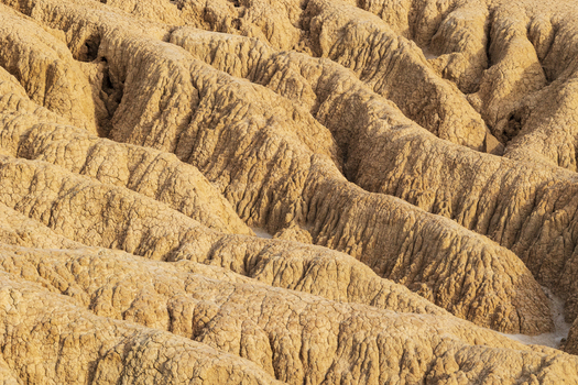 View of the unique eroded clay formations and deep ridges of the Bardenas Reales semi desert landscape in Navarre Navarre Spain. View of the unique eroded clay formations and deep ridges of the Bardenas Reales semi desert landscape in Navarre Navarre Spain.