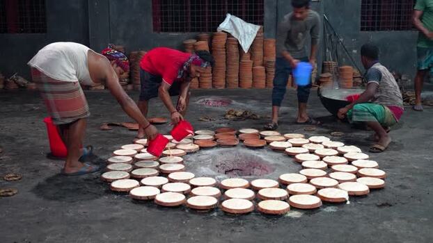 View of men preparing traditional Bogura curd Bangladesh. View of men preparing traditional Bogura curd Bangladesh.