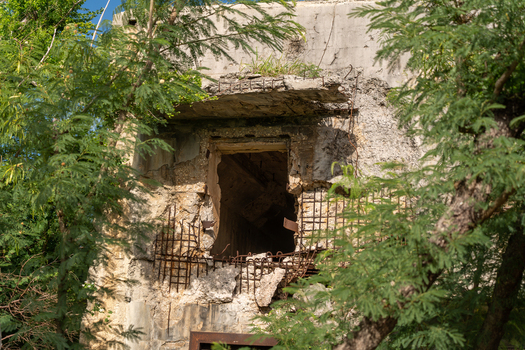 View of the historic North Field Base ruins with weathered concrete walls and exposed rebar in Northern Tinian Tinian Northern Mariana Islands. View of the historic North Field Base ruins with weathered concrete walls and exposed rebar in Northern Tinian Tinian Northern Mariana Islands.