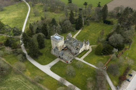 Aerial view of Drum Castle Garden and Estate National Trust for Scotland featuring the historic stone tower and surrounding green lawns Drumoak Scotland United Kingdom.