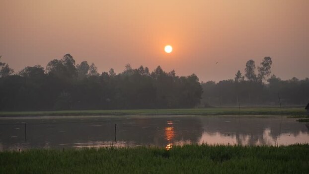 View of sunset over a tranquil pond in Bogura Bangladesh. View of sunset over a tranquil pond in Bogura Bangladesh.