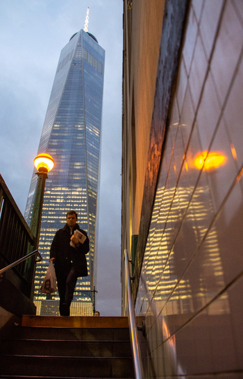 New York United States 14 May 2026 View of One World Trade Center from a subway entrance with a man walking up the stairs and a glowing street lamp at dusk. New York United States 14 May 2026 View of One World Trade Center from a subway entrance with a man walking up the stairs and a glowing street lamp at dusk.