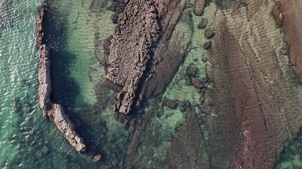 Aerial view of Praia das Avencas rocky coastline Portugal.