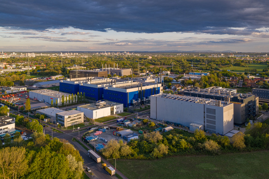 Aerial view of Digital Realty Frankfurt FRA30 data center complex with modern industrial buildings and surrounding green landscape Frankfurt am Main Hessen Germany. Aerial view of Digital Realty Frankfurt FRA30 data center complex with modern industrial buildings and surrounding green landscape Frankfurt am Main Hessen Germany.
